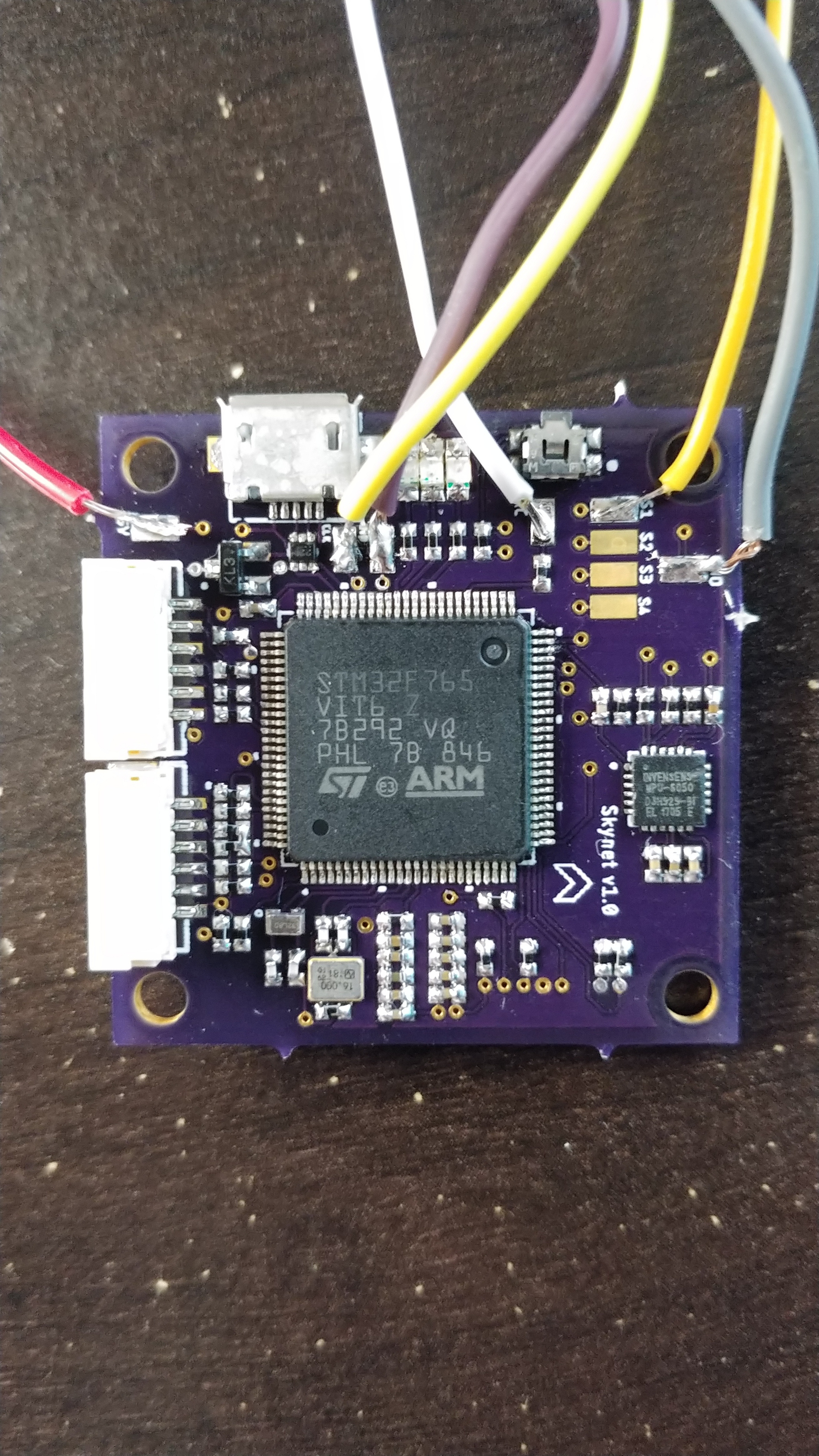 Assembled custom flight controller PCB with STM32 MCU